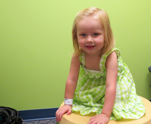 Ada Zeitz, 2, tries to have some fun at her Kidney Stones Clinic visit while her mom and dad meet with the multidisciplinary team.