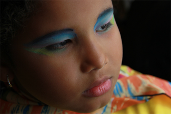A photo of a young person wearing make-up.