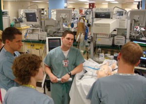 Dr. Sawyer (center) leading a NEST Program simulation training