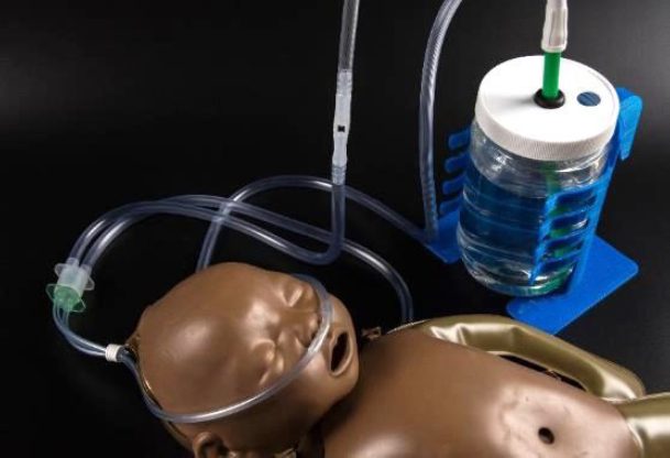 A doll with medical tubes going into its nose.