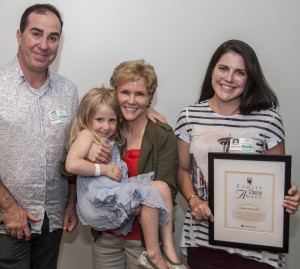 Dr. Kendra Smith (center) holds a former patient, Julia LaBelle, daughter of Colleen LaBelle (right), outgoing chair of the Family Advisory Council. At left is Julia's dad, Josh LaBelle.