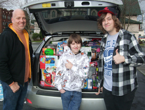 Travis, Turner and Tynan Patterson (from left to right) packed the car for last year’s toy drive for Children’s.